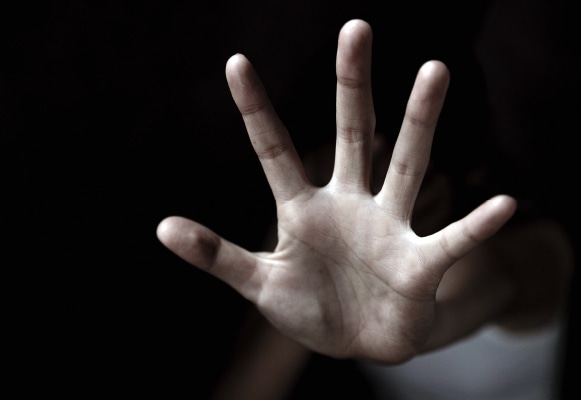hand reaching out of darkness, COVID-19 domestic abuse and violence