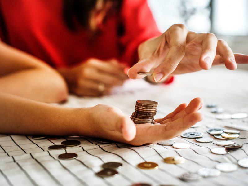 paying someone in coins on table, Cost of Living Crisis and Maintenance Payments